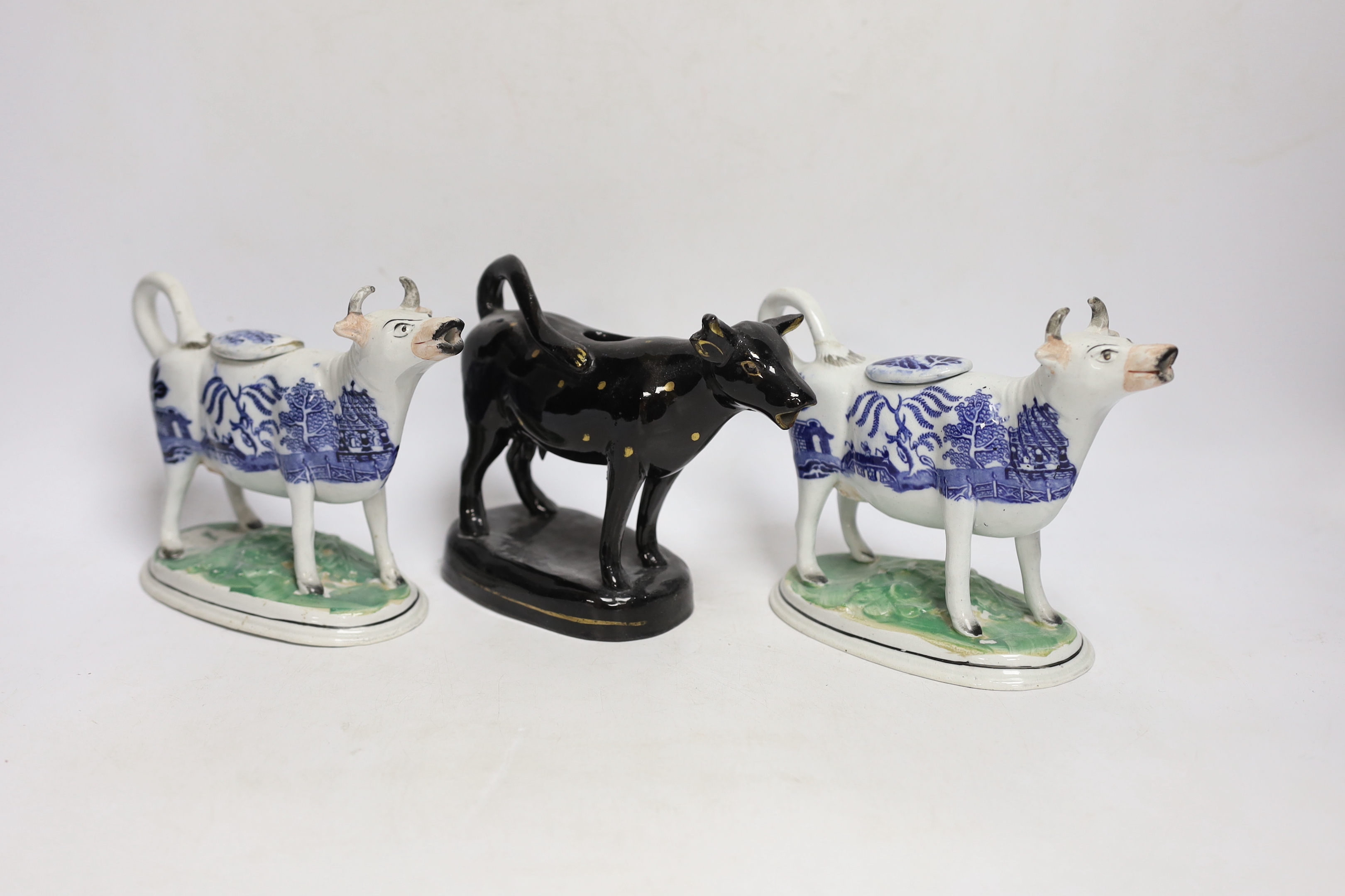 Five 19th century Staffordshire cow creamers, largest 18cm wide